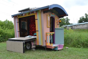 This little caravan, seen at the Todd parade, serves as a stage for traveling plays and puppet shows.